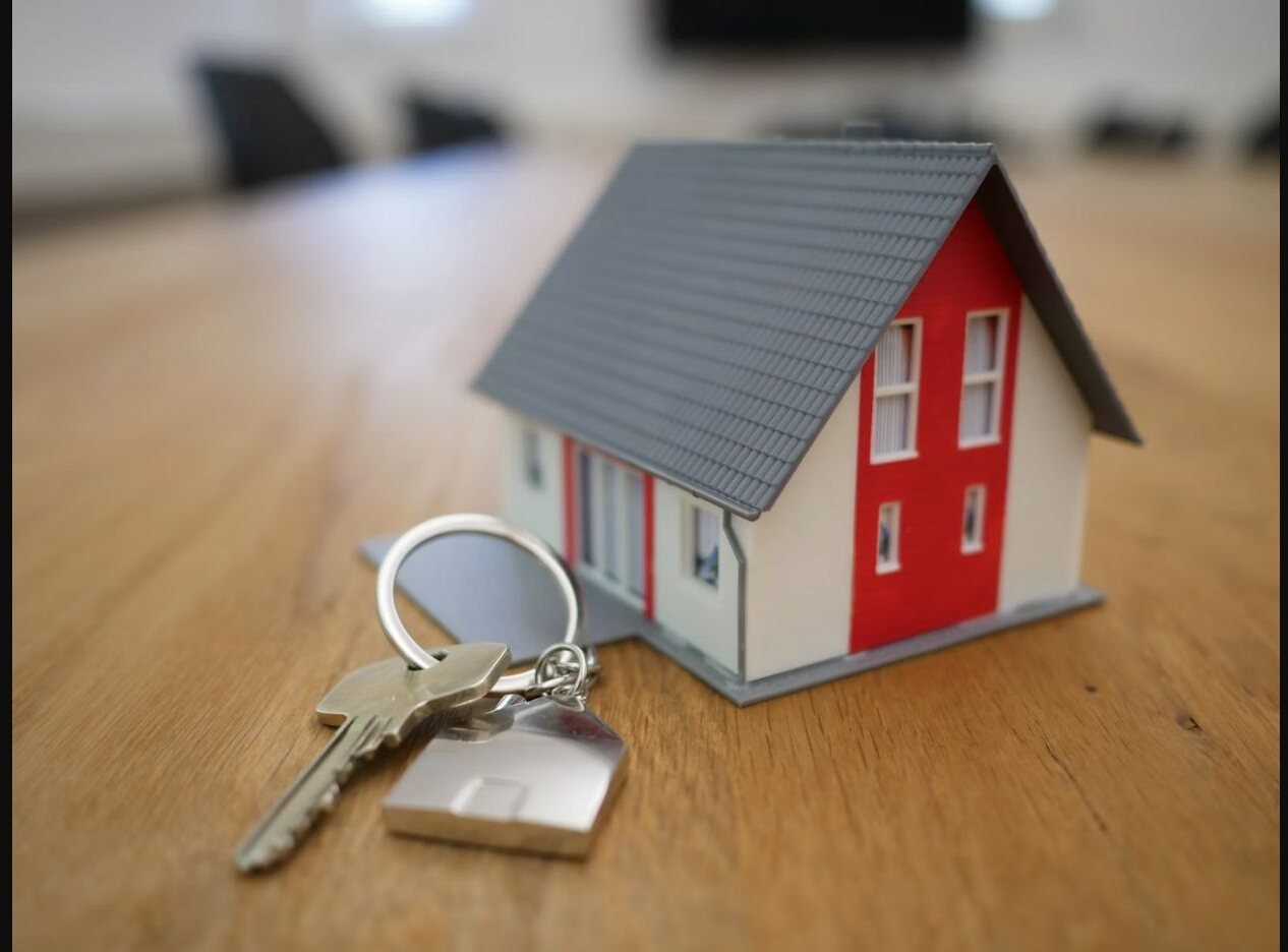 A property advisor handing over house keys during a consultation